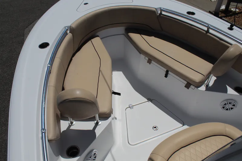 Slide: The Image of The image shows the bow area of a 2019 Sportsman Open 232 Center Console boat with beige upholstery. - 18