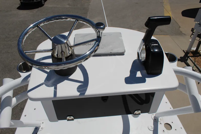 Slide: The Image of The image shows the helm of a 2019 Sportsman Open 232 Center Console boat. - 28