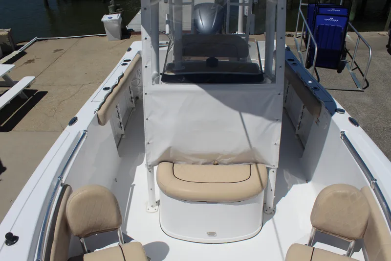 Slide: The Image of A 2019 Sportsman Open 232 Center Console boat with beige seating and a helm station. - 20