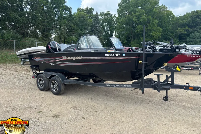 The Image of 2023 Ranger VX1788 WT boat on trailer, parked outdoors with trees in background. - 0