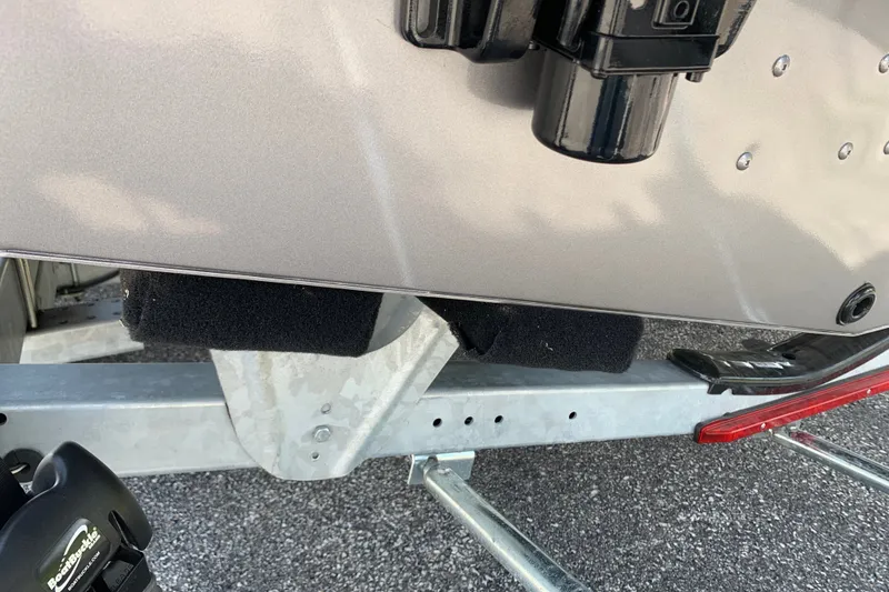 Slide: The Image of 2025 Lund 2075 Impact XS boat on trailer, close-up of hull and support. - 25