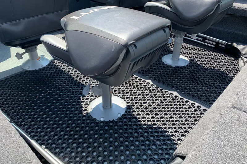 Slide: The Image of 2025 Lund 2075 Impact XS boat interior with black seating and textured flooring. - 17