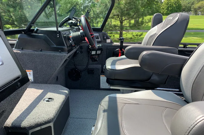 Slide: The Image of 2025 Lund 2075 Impact XS boat interior with modern seating and steering console. - 20