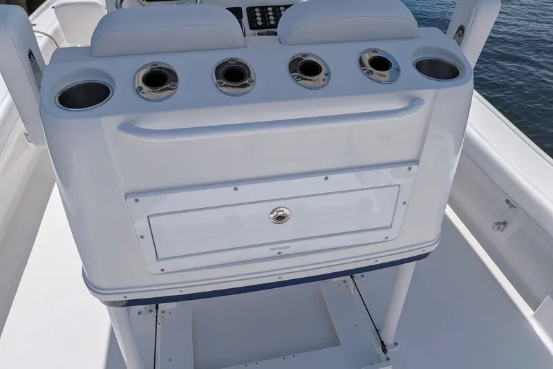 Slide: The Image of 2027 Caymas 26 HB boat console with cup holders and storage compartment. - 13