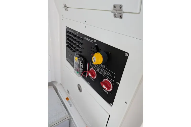 Slide: The Image of Control panel of 2027 Caymas 26 HB boat, featuring switches and voltage indicators. - 15