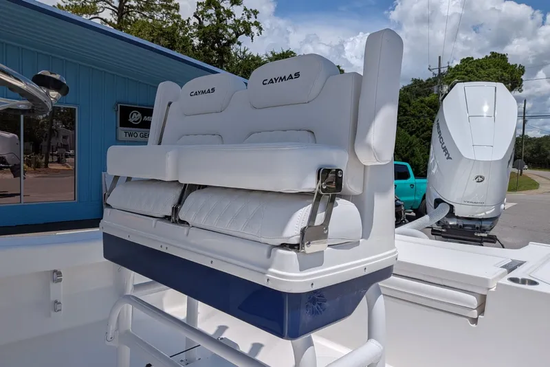 Slide: The Image of 2027 Caymas 26 HB boat with white seating and Mercury outboard motor. - 12
