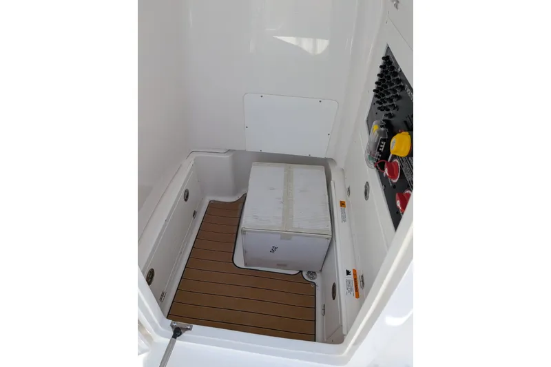 Slide: The Image of Interior of 2027 Caymas 26 HB boat with storage compartment and control panel. - 14