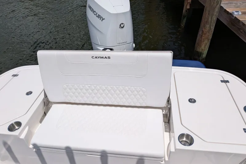 Slide: The Image of 2027 Caymas 26 HB boat with white seating and Mercury outboard motor. - 7