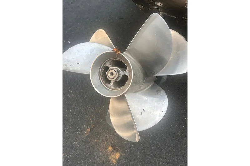 Slide: The Image of Propeller of a 2002 Wellcraft 2600 Martinique boat on asphalt surface. - 14
