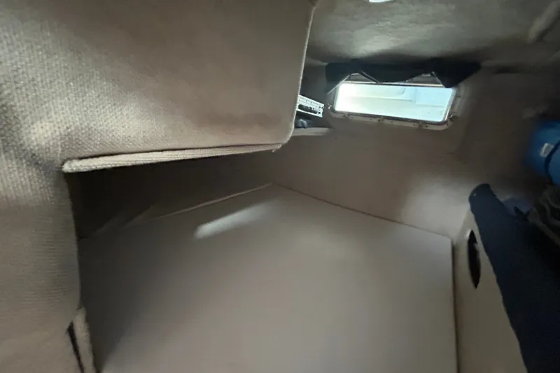 Slide: The Image of Interior cabin of 2002 Wellcraft 2600 Martinique boat, featuring a compact sleeping area. - 7