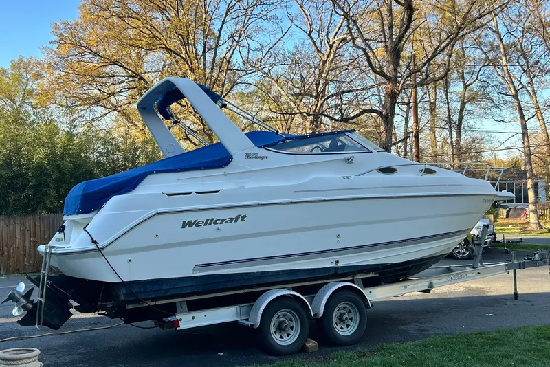 Slide: The Image of 2002 Wellcraft 2600 Martinique boat on trailer, parked outdoors. - 15