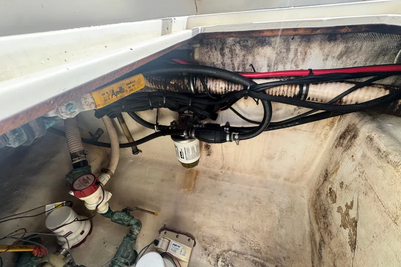 Slide: The Image of Bilge area of a 2003 Contender 25 Open boat showing hoses and fittings. - 45