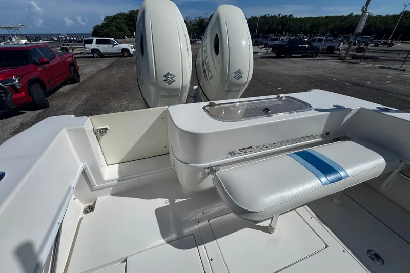 Slide: The Image of 2003 Contender 25 Open boat interior with Suzuki engines and seating area. - 38