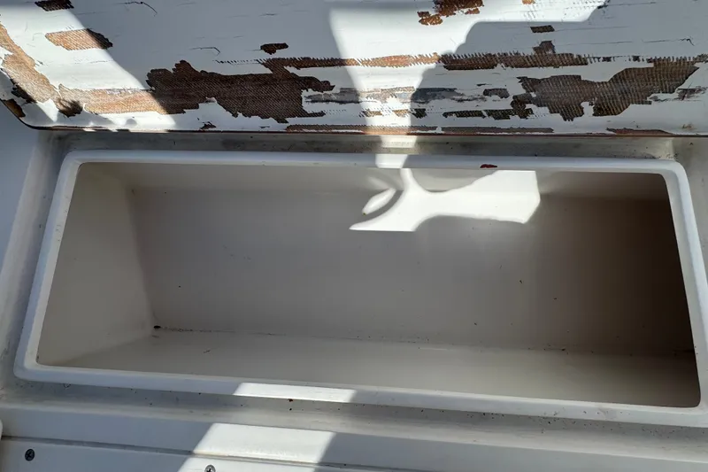 Slide: The Image of Open storage compartment on a 2003 Contender 25 Open boat, showing wear and tear. - 43
