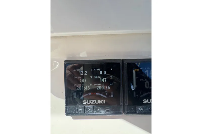 Slide: The Image of Suzuki engine display on 2003 Contender 25 Open boat, showing various metrics. - 51