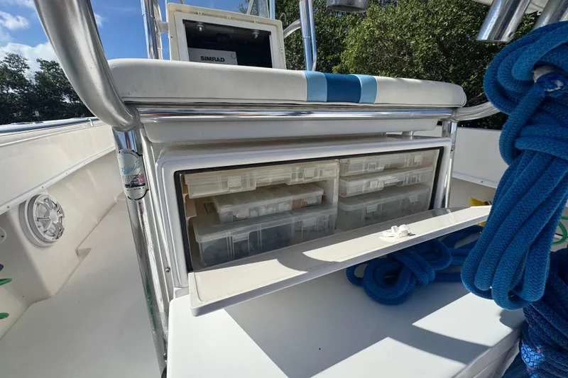 Slide: The Image of 2003 Contender 25 Open boat with storage compartments and blue rope on deck. - 42
