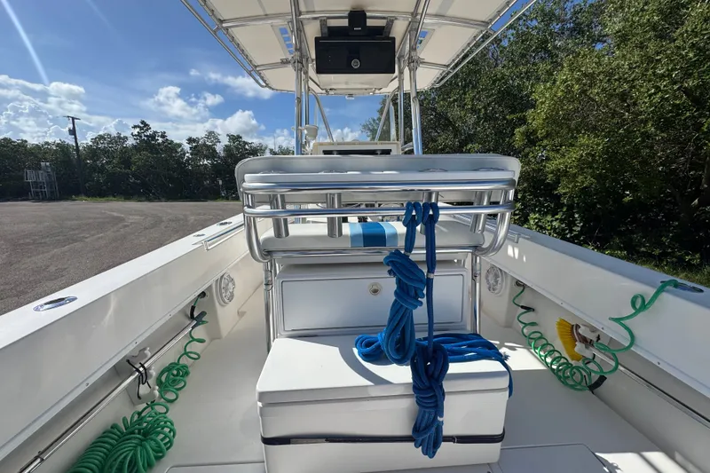 Slide: The Image of 2003 Contender 25 Open boat interior with ropes and storage, under sunny skies. - 40