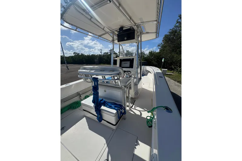 Slide: The Image of 2003 Contender 25 Open boat interior with console, seating, and equipment under a clear sky. - 48