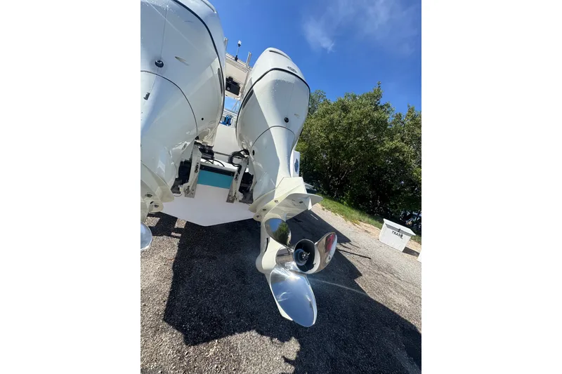 Slide: The Image of 2003 Contender 25 Open boat with dual outboard motors on a sunny day. - 33