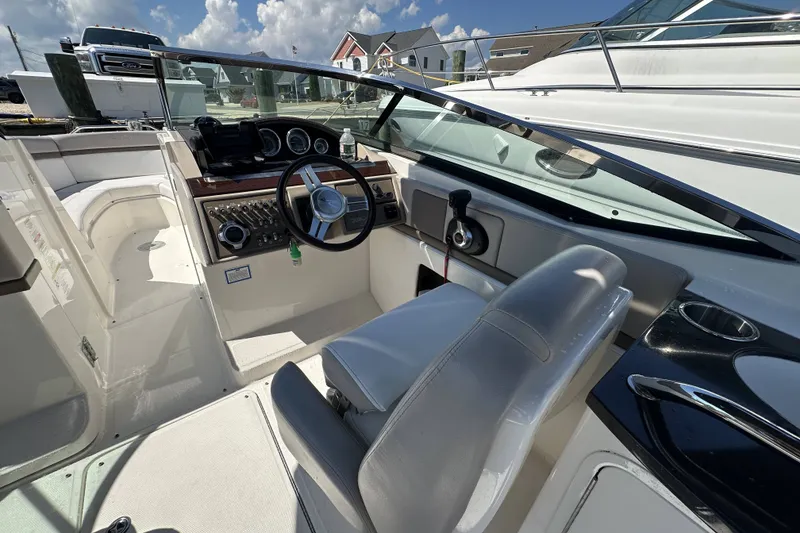 Slide: The Image of 2012 Sea Ray SLX 250 boat interior with steering wheel and dashboard controls. - 10