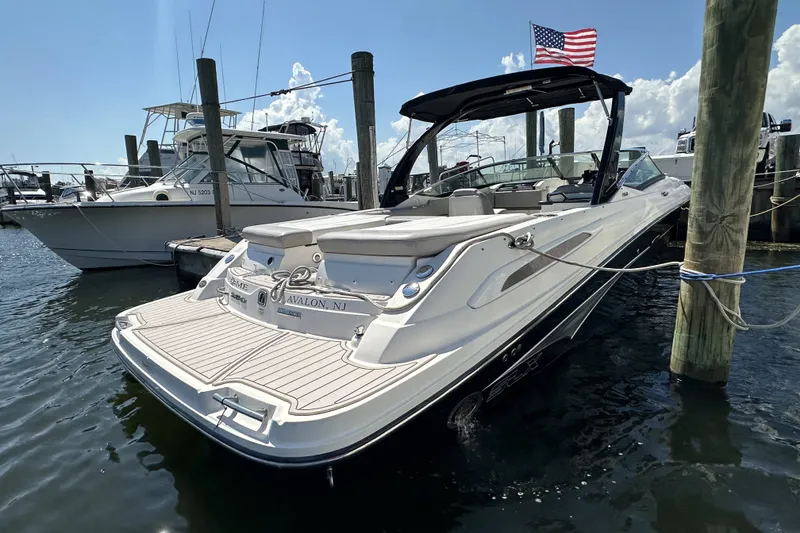 Slide: The Image of 2012 Sea Ray SLX 250 boat docked in Avalon, NJ marina with American flag. - 17