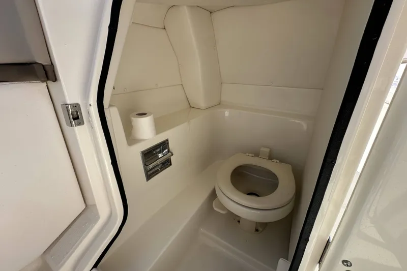 Slide: The Image of Interior view of 2012 Sea Ray SLX 250 boat bathroom with toilet and toilet paper. - 13