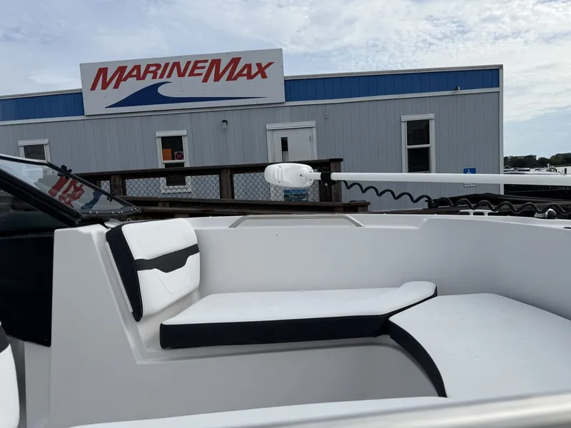 Slide: The Image of The image shows the cockpit of a Four Winns HD 200 Freedom boat in front of a MarineMax building. - 21
