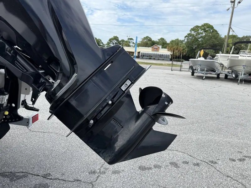 Slide: The Image of Close-up of an outboard motor with propeller in a parking lot. - 9