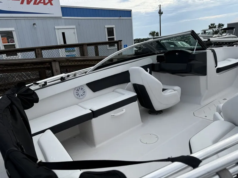Slide: The Image of The image shows the cockpit of a 2019 Four Winns HD 200 Freedom boat with white and black seating. - 13