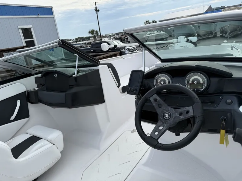 Slide: The Image of The image shows the cockpit of a 2019 Four Winns HD 200 Freedom boat with a modern helm. - 18