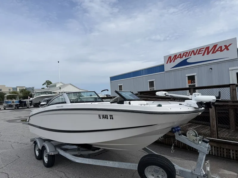 Slide: The Image of A white 2019 Four Winns HD 200 Freedom boat on a trailer in front of a MarineMax building. - 1