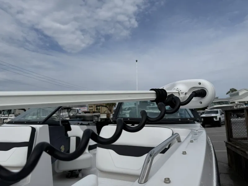 Slide: The Image of A 2019 Four Winns HD 200 Freedom with white interior and a mounted device on the deck. - 25