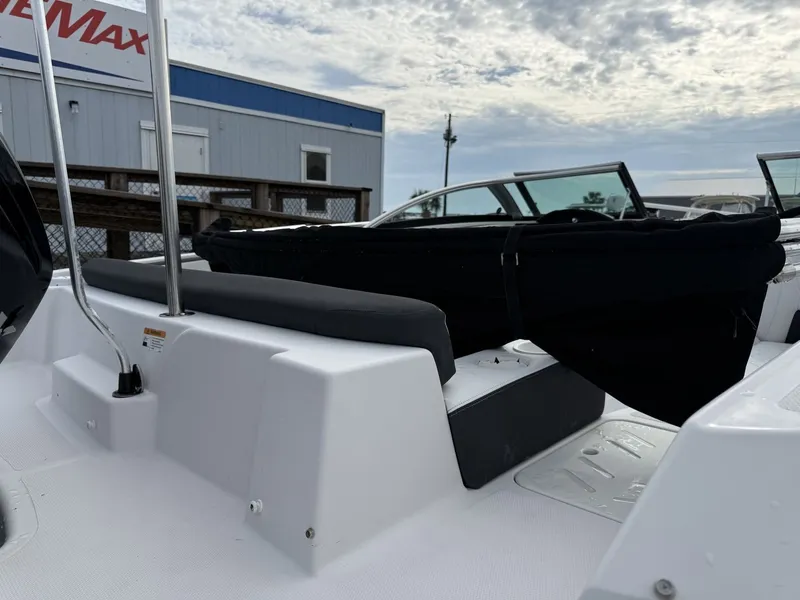 Slide: The Image of The image shows the deck of a 2019 Four Winns HD 200 Freedom boat with black seating. - 12