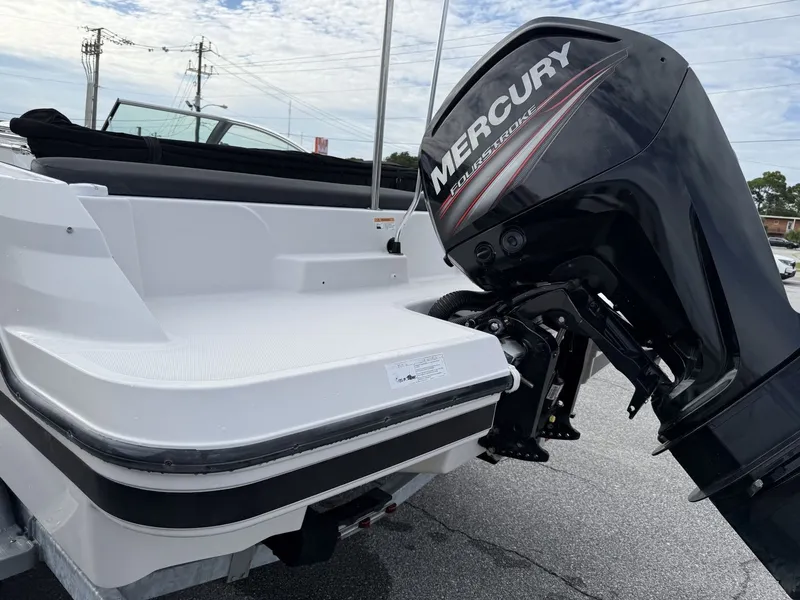 Slide: The Image of A 2019 Four Winns HD 200 Freedom with a Mercury outboard motor, on a trailer. - 7