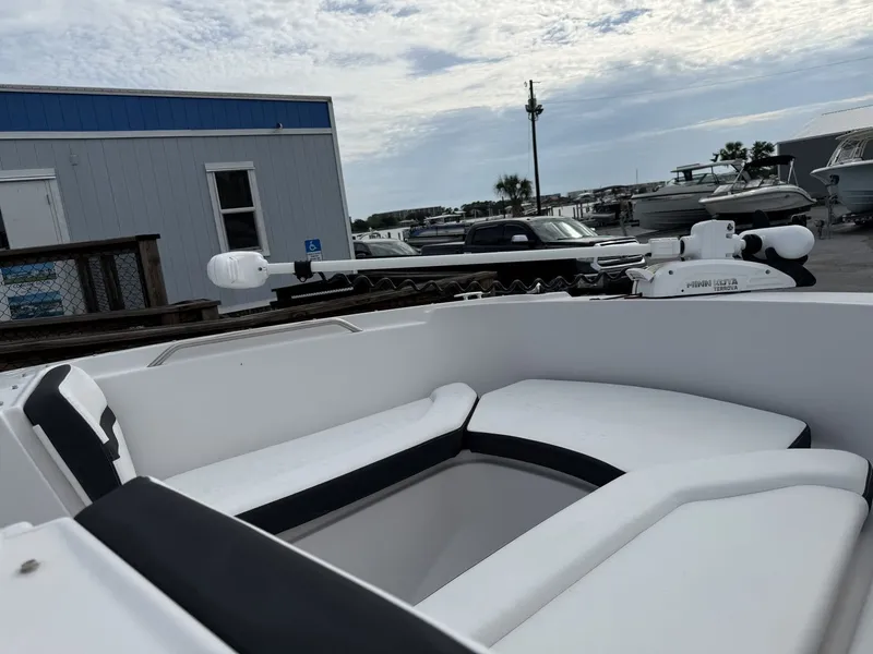 Slide: The Image of The image shows the cockpit of a 2019 Four Winns HD 200 Freedom boat with white and black seating. - 20