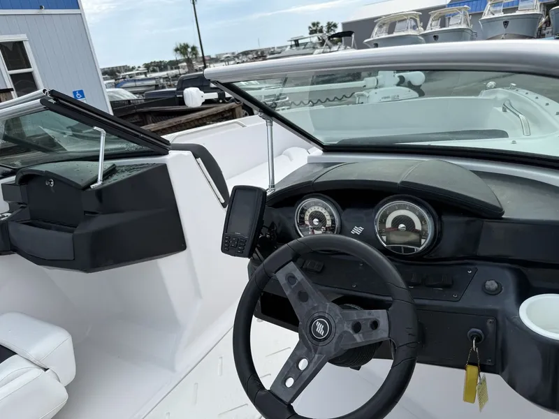 Slide: The Image of The image shows the cockpit of a 2019 Four Winns HD 200 Freedom with steering wheel and dashboard. - 19