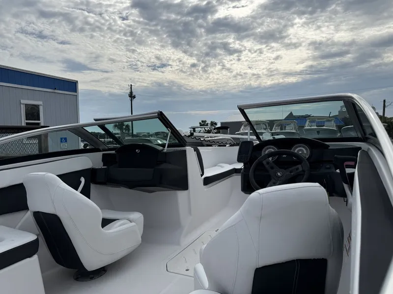 Slide: The Image of The image shows the cockpit of a 2019 Four Winns HD 200 Freedom boat with white seats. - 16