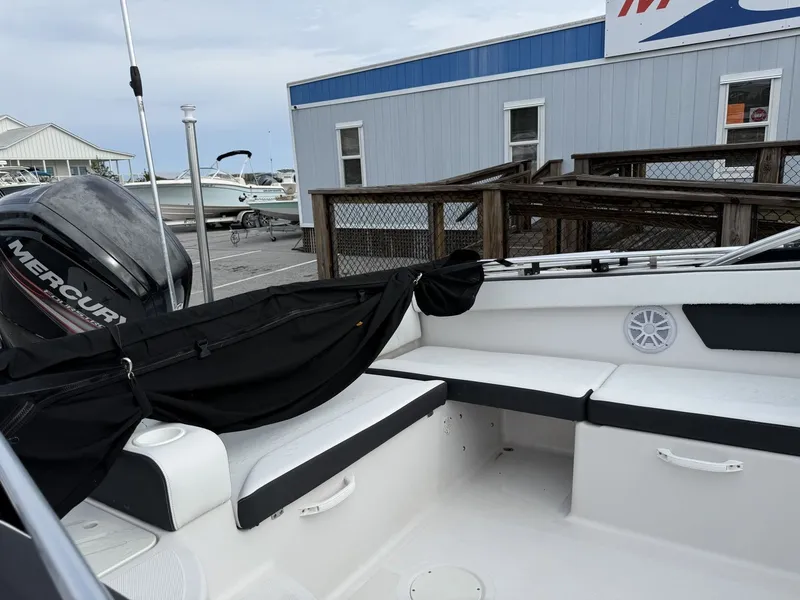 Slide: The Image of The image shows the cockpit of a 2019 Four Winns HD 200 Freedom boat with white seating. - 17