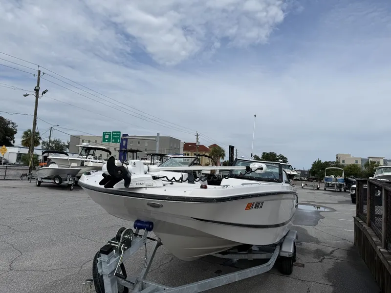Slide: The Image of A 2019 Four Winns HD 200 Freedom on a trailer, parked on a paved lot. - 3