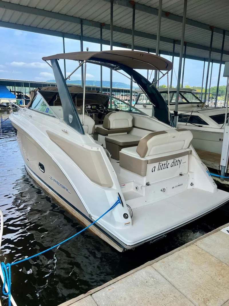 Slide: The Image of A 2017 Regal 26 Express boat docked in a covered marina. - 1