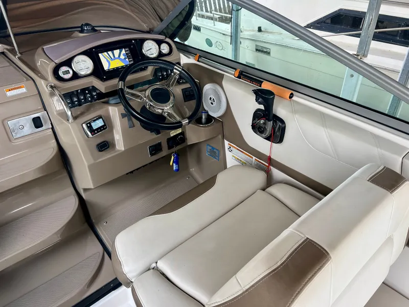 Slide: The Image of The cockpit of a 2017 Regal 26 Express with a modern helm and comfortable seating. - 11