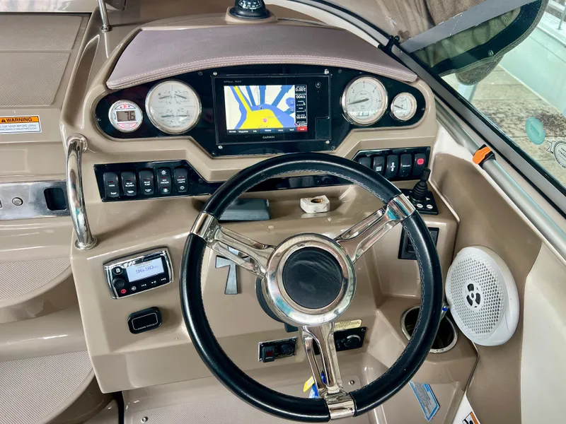 Slide: The Image of The cockpit of a 2017 Regal 26 Express featuring a modern helm and navigation system. - 12