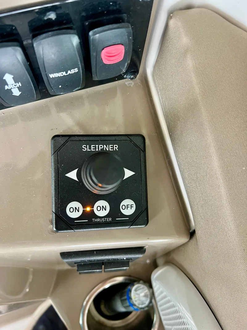 Slide: The Image of Close-up of a control panel featuring a thruster switch, surrounded by additional switches. - 13