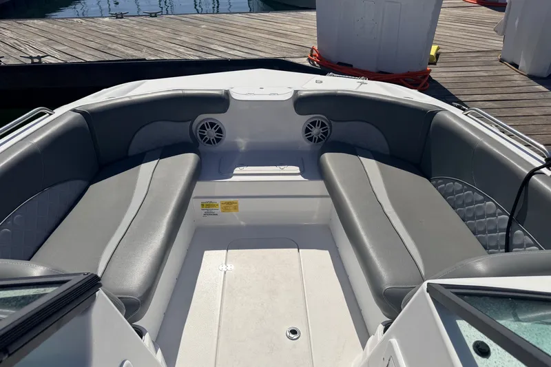 Slide: The Image of 2026 NauticStar 203 DC Deck boat interior with gray seating and speakers. - 20