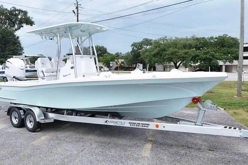 Slide: The Image of 2027 BlackJack 256 Coastal boat on trailer, parked outdoors, showcasing sleek design and modern features. - 14