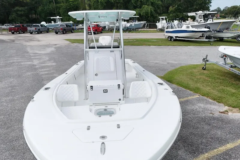 Slide: The Image of 2027 BlackJack 256 Coastal boat displayed in a marina with other vessels. - 13