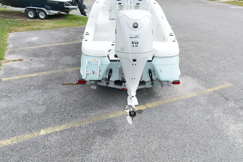Slide: The Image of 2027 BlackJack 256 Coastal boat with Yamaha V6 engine in parking lot. - 2