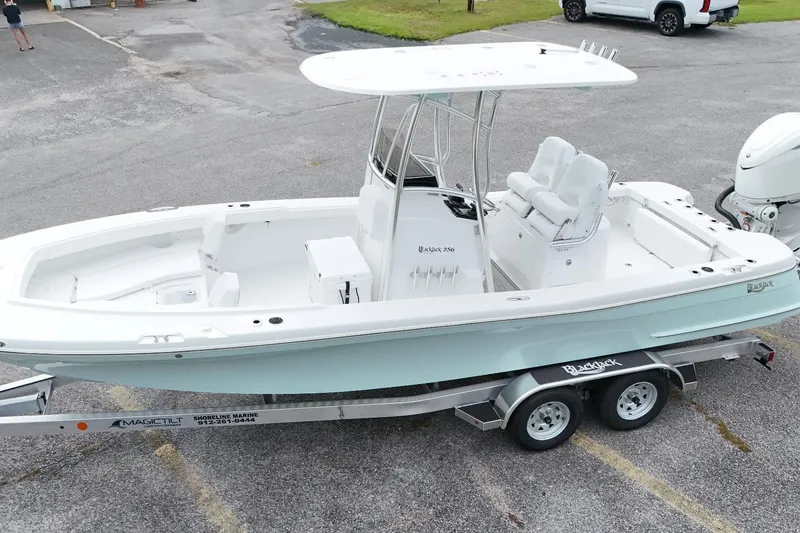 Slide: The Image of 2027 BlackJack 256 Coastal boat on trailer, parked in a lot, ready for transport. - 15