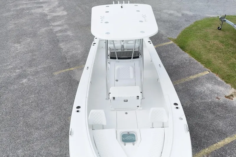 Slide: The Image of Aerial view of 2027 BlackJack 256 Coastal boat on pavement, showcasing sleek design and spacious deck. - 7