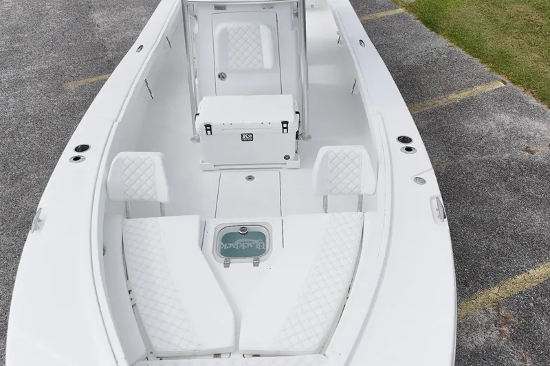 Slide: The Image of 2027 BlackJack 256 Coastal boat interior with white seating and storage compartments. - 12